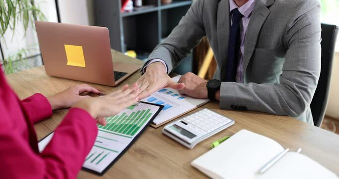 Colleagues play rock paper scissors game at workplace