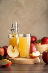 Apple juice drink with fresh red apples, wooden background