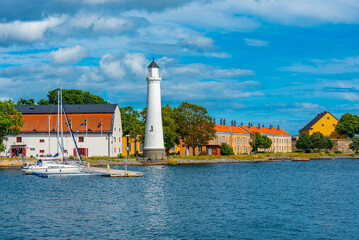 Lighthouse at traditional port buildings in Karlshamn, Sweden.