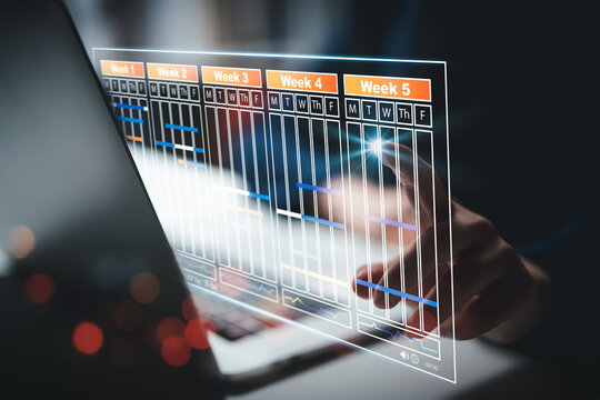 Planning and Implementation, Business people use laptop computers to manage work projects and update tasks. Work progress, efficient scheduling.Business Data Management scheduling interface