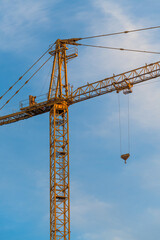 Yellow industrial construction crane machinery on site