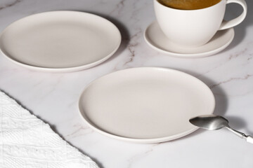 Empty plates and coffee on a light table