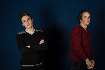 Two young attractive students are posing in the studio.