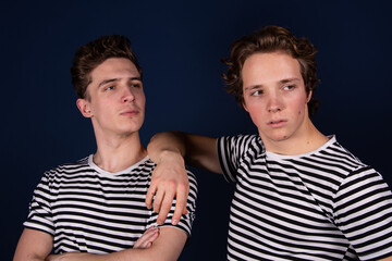 Two young attractive students are posing in the studio.