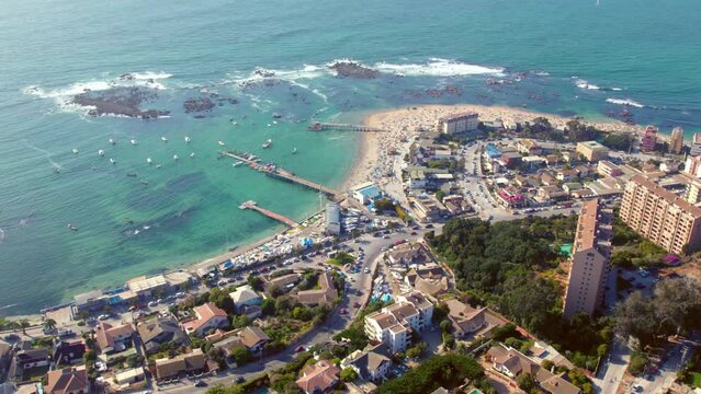 Establishing shot of the tropical waters with tourists on Pejerrey beach, Chile