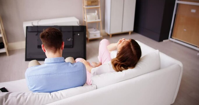 Man Sitting On Sofa In Front Fallen Television