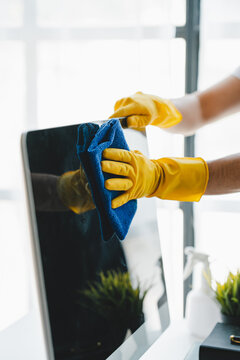 people doing cleaning are using cloths and spraying disinfectant Wipe the desk and floor in the office room..cleaning staff.cleaning maid