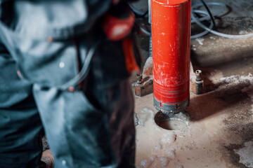 Drilling a hole into a concrete floor with core driller
