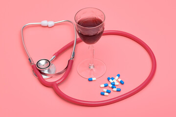 Stetoskop wino i lekarstwa na różowym tle - obrazy, fototapety, plakaty
