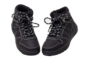 Winter boots. Close-up of a pair elegant black leather winter boots with laces and rivets isolated on white. Macro. Autumn shoe fashion for child boy.