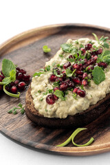 Baba ghanoush eggplant dip and pomegranate seeds on toast