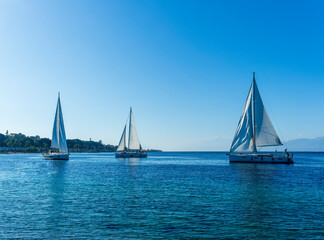 boats and yachts at the sailing regatta on open water. Sailing on the wind waves in the sea.