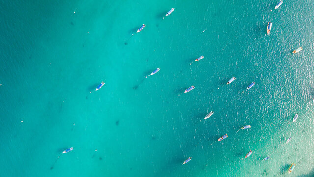 Aerial shot of boat at the sea. bluish water. contains noise and film grain due to High.