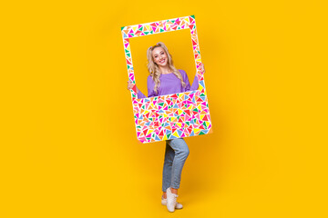 Full body photo of attractive young woman photo frame social media post dressed stylish violet outfit isolated on yellow color background