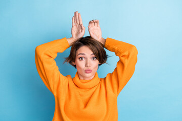 Photo portrait of lovely young lady playing hands bunny rabbit ears dressed stylish orange clothes...