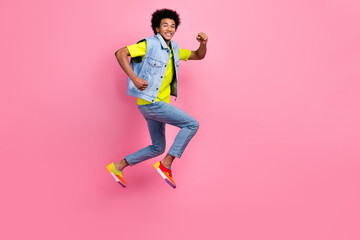 Fototapeta na wymiar Full length photo of cheerful glad man wear bright comfort clothes hurry store mall empty space isolated on pink color background