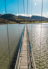 Fototapeta premium The longest suspension bridge in Bulgaria over Studen Kladenez dam with distance between the two towers of 260m. The only way to reach Lisicite villag