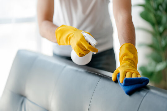 people doing cleaning are using cloths and spraying disinfectant Wipe the sofa in the office room or at home.