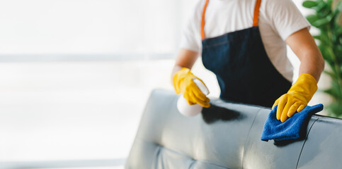 people doing cleaning are using cloths and spraying disinfectant Wipe the sofa in the office room or at home.