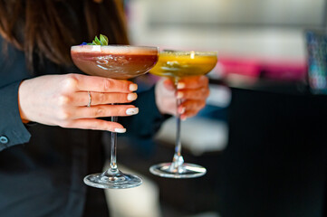 young woman waitress with cocktail drinks at restaurant