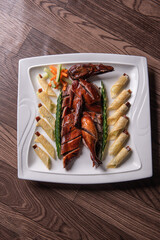 Beijing roasted whole big pipa bbq duck with crepe skin roll and vegetables on wood table background asian Chinese halal banquet meat menu 
