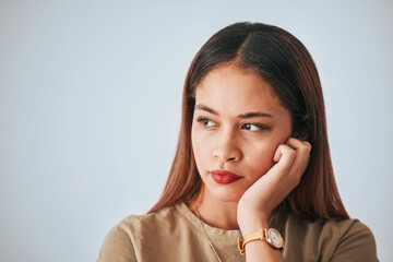 Serious woman, thinking and space for idea in studio with advertising or product placement. Face of female on white background with doubt, planning or contemplating problem, plan or decision