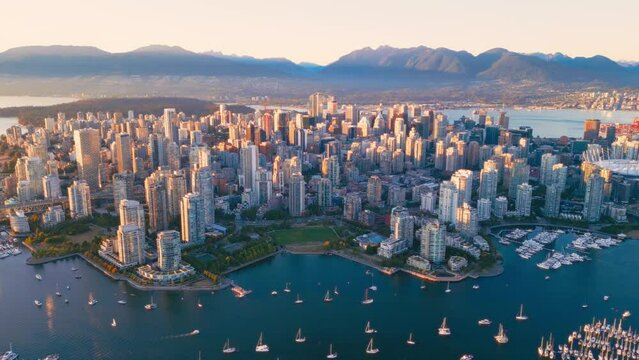 Vancouver downtown skyline aerial crane down shot, BC, Canada at sunset