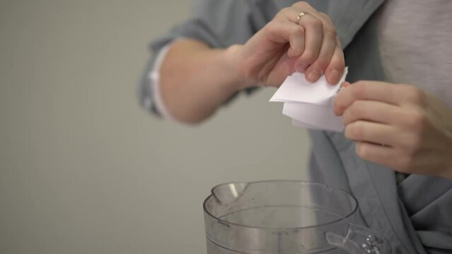 a woman in a shirt tears a sheet of paper into pieces. slow motion video. slow motion video. High quality Full HD video recording