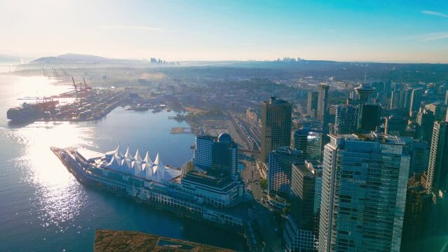 Aerial flythrough downtown Vancouver Harbour skyline, BC, Canada at sunrise