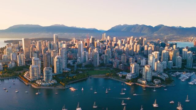 Vancouver downtown skyline aerial crane up shot, BC, Canada at sunset