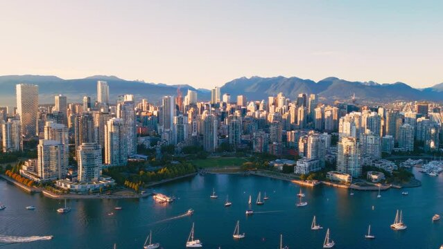 Vancouver downtown skyline aerial crane down shot, BC, Canada at sunset