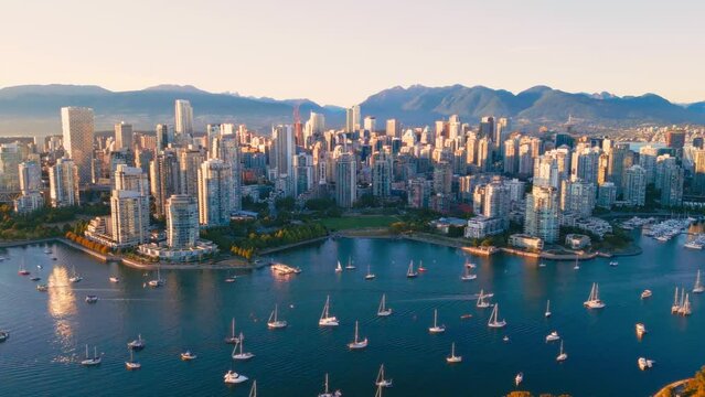 Vancouver downtown skyline aerial crane up shot, BC, Canada at sunset