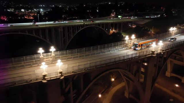 Cinematic aerial tracking bus on Colorado Street Bridge in Pasadena at night
