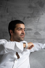 Hispanic young man sending voicemail on smart watch