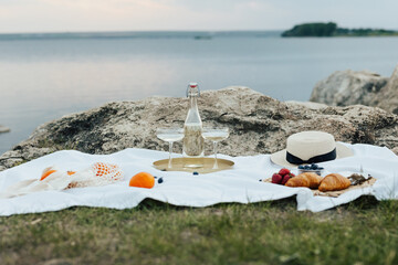 Concept of summer delicious picnic on the rocky hill with amazing view on the sea. Beautiful summer...