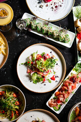 variety of restaurant food dishes on table. top view.