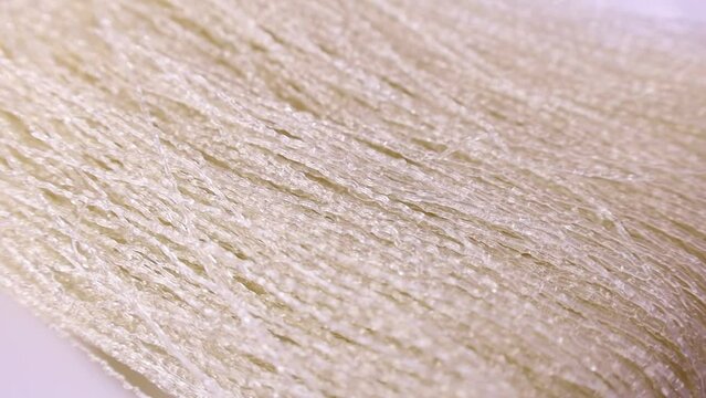 Uncooked dry transparent white arrowroot noodles circle rotation close up