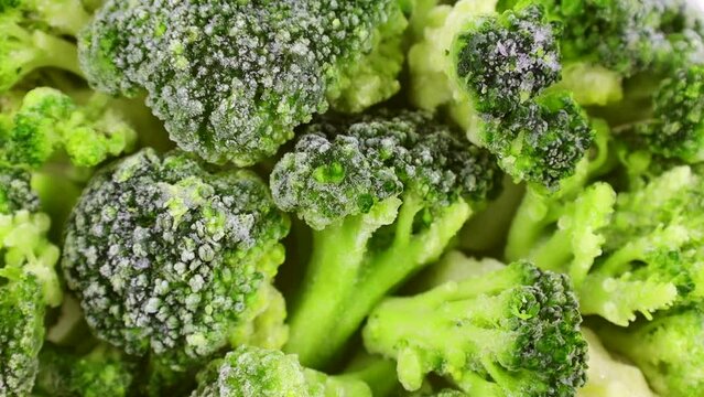 Frozen broccoli top view, rotation. Chopped broccoli. Healthy vegan food concept