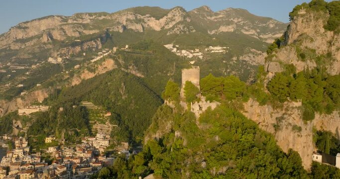 Aerial Panning Shot Of Torre Dello Ziro Watchover On Mountain During Sunny Day - Amalfi, Italy
