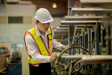 A new generation of engineers in a metal sheet factory.  Studying work methods from supervisors or colleagues and studying by yourself  be taught professionally