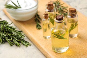 Rosemary essential oil and cream on a light background. face and body skin care. spa.