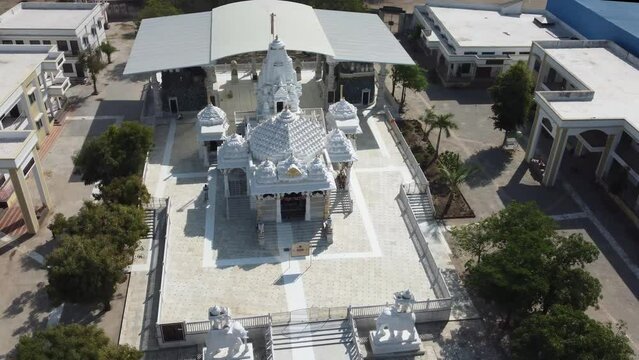 Unhel, Rajasthan, India 12th March 2023: 4k Drone shots of Shri Nageshwar Parshwanath Tirth or Shri Jain Shwetamber Nageshwar Parshwanath Tirth Pedhi is a Jain Temple. Standing Jain Murti or Idol.