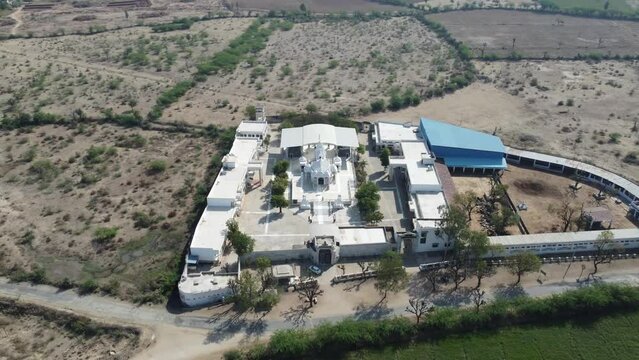 Unhel, Rajasthan, India 12th March 2023: 4k Drone shots of Shri Nageshwar Parshwanath Tirth or Shri Jain Shwetamber Nageshwar Parshwanath Tirth Pedhi is a Jain Temple. Standing Jain Murti or Idol.