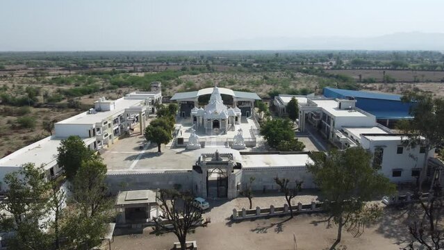 Unhel, Rajasthan, India 12th March 2023: 4k Drone shots of Shri Nageshwar Parshwanath Tirth or Shri Jain Shwetamber Nageshwar Parshwanath Tirth Pedhi is a Jain Temple. Standing Jain Murti or Idol.