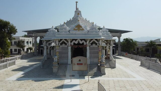 Unhel, Rajasthan, India 12th March 2023: 4k Drone shots of Shri Nageshwar Parshwanath Tirth or Shri Jain Shwetamber Nageshwar Parshwanath Tirth Pedhi is a Jain Temple. Standing Jain Murti or Idol.