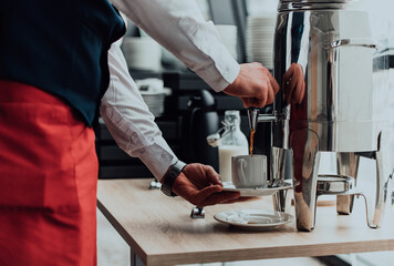 The waiter preparing coffee for hotel guests. Close up photo of service in modern hotels