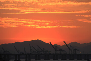 Silhouette of cranes on the pier in the evening. Rio de Janeiro, Brazil.