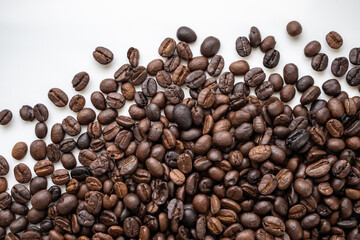 Fresh roasted brown coffee beans on white background
