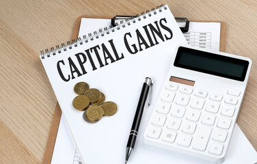 CAPITAL GAINS text with chart and calculator and coins , business concept