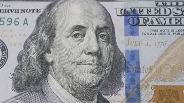A close-up of a hundred dollar bill featuring Benjamin Franklin, the iconic symbol of American finance and success. The perfect representation of wealth, prosperity and credit exchange.